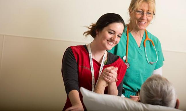 A volunteer and provider with a patient